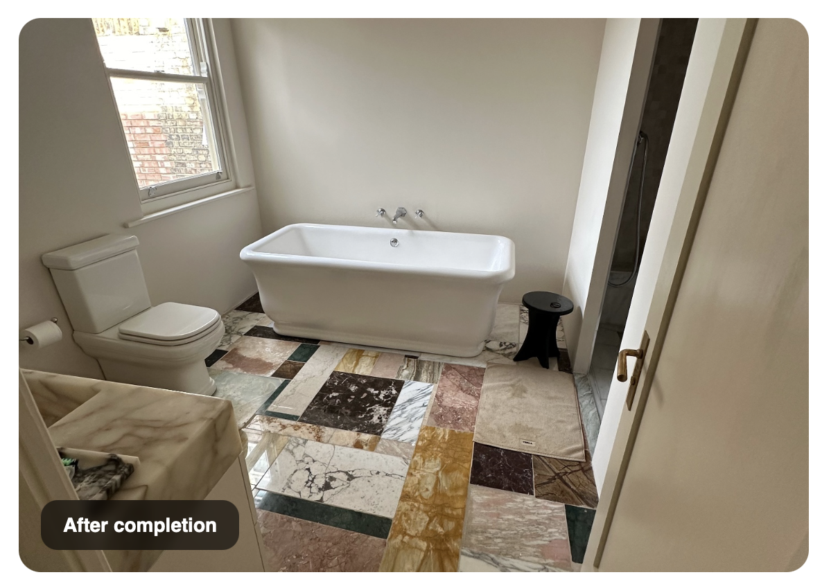 Completed bathroom with freestanding bath and marble tiling