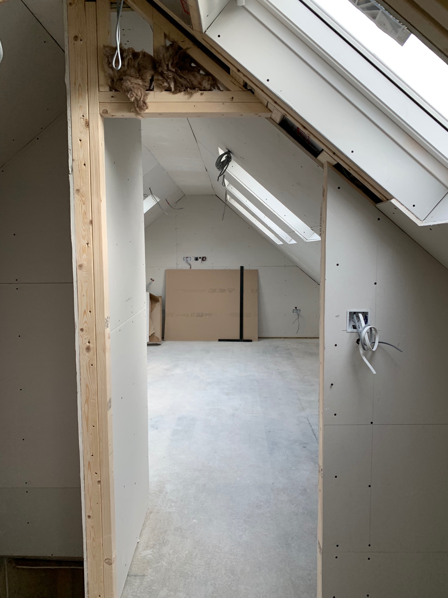Loft conversion construction in progress with dormer window